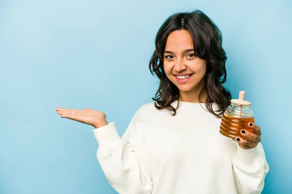 Young Hispanic Woman Holding Honey Isolated Blue Background Showing Copy — Zdjęcie stockowe