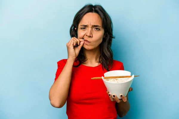 Young Hispanic Woman Eating Noodles Isolated Blue Background Fingers Lips —  Fotos de Stock