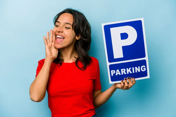 Ung Latinamerikansk Kvinna Håller Parkerings Skylt Isolerad Blå Bakgrund Skrika — Stockfoto