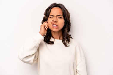 Beyaz arka planda izole edilmiş, kulaklarını parmaklarıyla kapatan, stresli ve çaresiz genç İspanyol kadın yüksek sesli bir ortam tarafından..