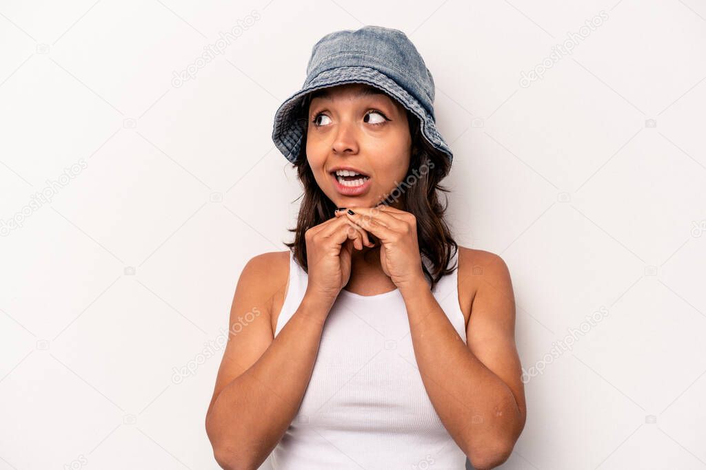 Young hispanic woman isolated on white background praying for luck, amazed and opening mouth looking to front.