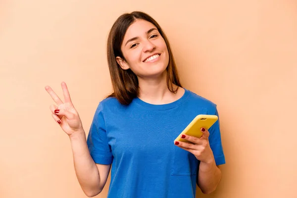 Young Caucasian Woman Holding Mobile Phone Isolated Beige Background Joyful — Stock Photo, Image