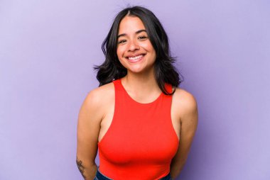 Mor arka planda izole edilmiş genç İspanyol kadın mutlu, güler yüzlü ve neşeli..