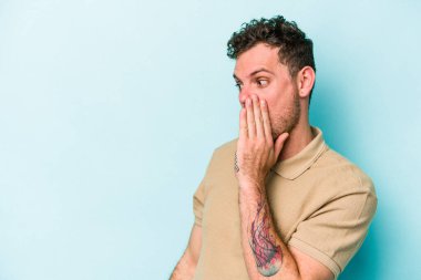 Kafkasyalı genç adam mavi arka planda izole edilmişti. Gördüğü bir şey yüzünden şok olmuştu..