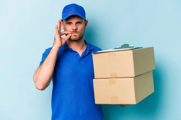 Young Caucasian Delivery Man Isolated Blue Background Fingers Lips Keeping — Φωτογραφία Αρχείου