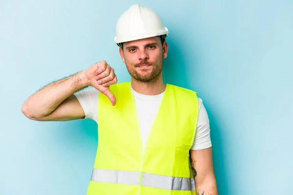 Young Laborer Caucasian Man Isolated Blue Background Showing Dislike Gesture — 스톡 사진