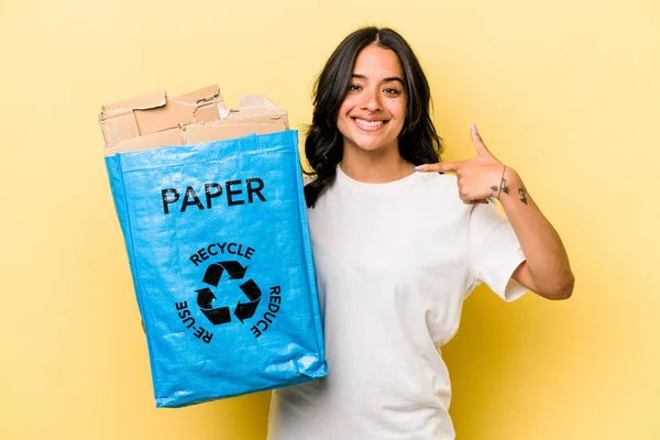 Young Hispanic Woman Recycling Paper Isolated Yellow Background Person Pointing — Stock fotografie