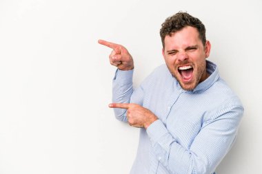 Beyaz arka planda izole edilmiş genç beyaz bir adam işaret parmağıyla işaret ettiği için heyecanlı..