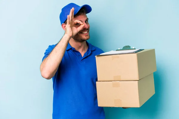 Young Caucasian Delivery Man Isolated Blue Background Excited Keeping Gesture — Foto de Stock