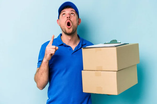 Young Caucasian Delivery Man Isolated Blue Background Pointing Upside Opened — Stockfoto