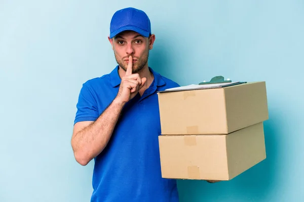 Young Caucasian Delivery Man Isolated Blue Background Keeping Secret Asking — Foto de Stock