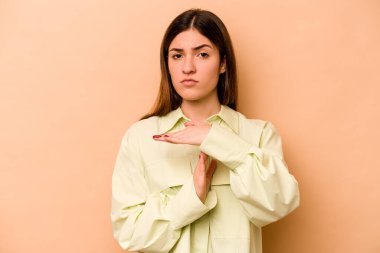 Latin kökenli genç bir kadın bej arka planda izole edilmiş..