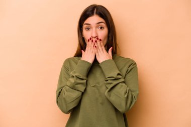 Latin kökenli genç bir kadın bej arka planda izole edilmiş..