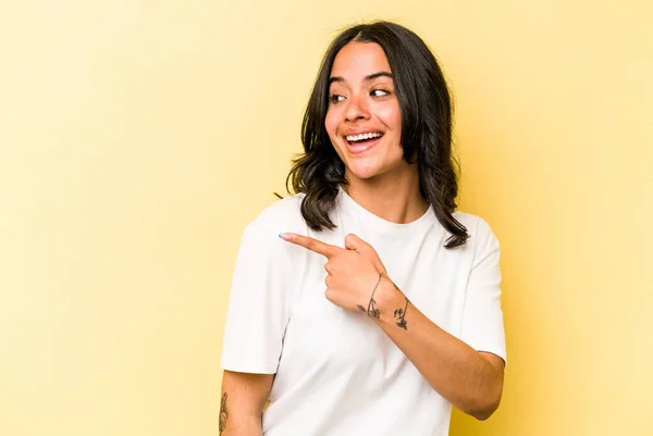 Young Hispanic Woman Isolated Yellow Background Looks Aside Smiling Cheerful — Foto Stock