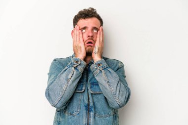 Beyaz arka planda ağlayan ve sızlanan beyaz tenli genç bir adam var..