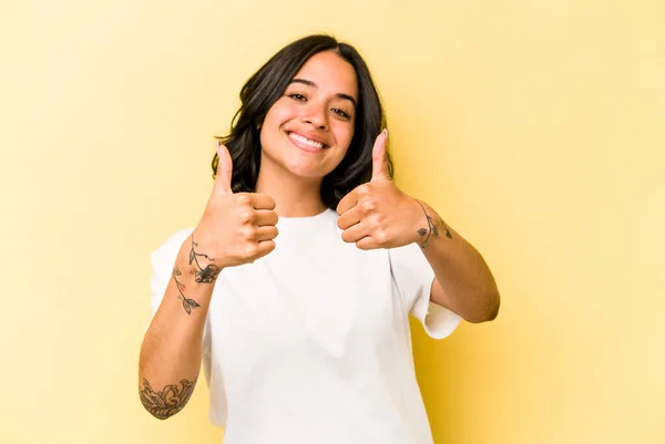 Young Hispanic Woman Isolated Yellow Background Raising Both Thumbs Smiling — 스톡 사진