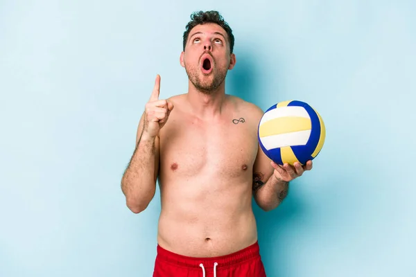 Young Caucasian Man Playing Volley Isolated Blue Background Pointing Upside — Stok fotoğraf