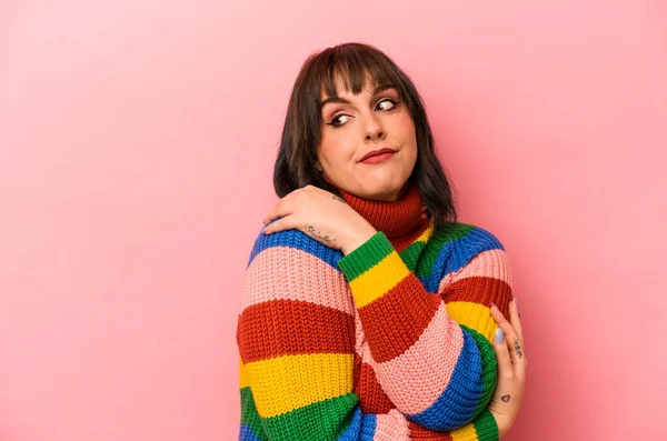 Pembe arka planda soyutlanmış beyaz bir kadın. Kucaklaşma, kaygısız gülümseme ve mutluluk..