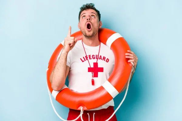Young Caucasian Lifeguard Man Isolated Blue Background Pointing Upside Opened — Fotografia de Stock
