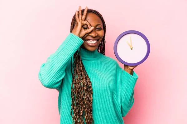 Ung Afroamerikansk Kvinna Håller Klocka Isolerad Rosa Bakgrund Upphetsad Hålla — Stockfoto