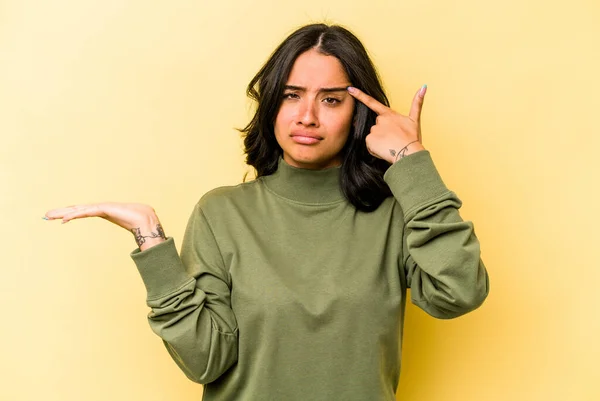 Young Hispanic Woman Isolated Yellow Background Showing Disappointment Gesture Forefinger — стоковое фото