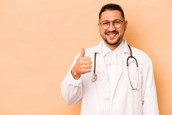 Hispanic Doctor Man Isolated Beige Background Smiling Raising Thumb — Stockfoto