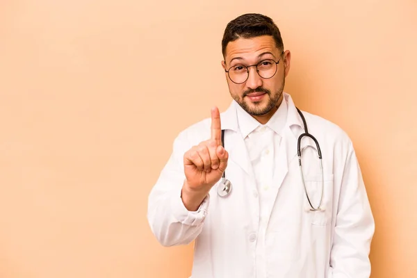 Hispanic Doctor Man Isolated Beige Background Showing Number One Finger — Stockfoto