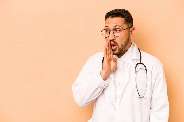 Hispanic Doctor Man Isolated Beige Background Saying Secret Hot Braking — Stock fotografie