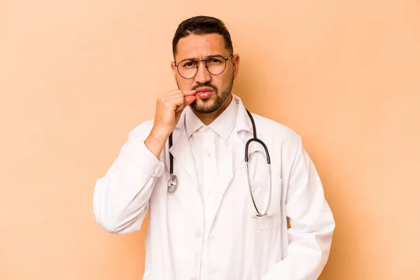 Hispanic Doctor Man Isolated Beige Background Fingers Lips Keeping Secret — Stockfoto