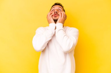 Genç İspanyol adam sarı arka planda yalnızdı sızlanıyor ve ağlıyordu..