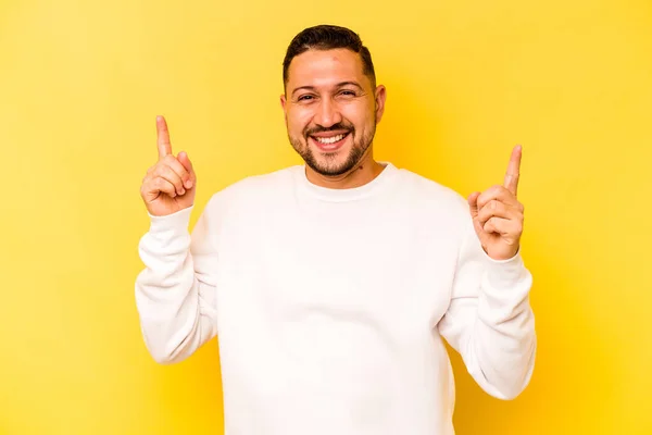 Jovem Hispânico Isolado Fundo Amarelo Indica Com Ambos Dedos Dianteiros — Fotografia de Stock