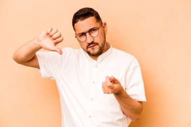 Latin kökenli genç bir adam bej arka planda izole edilmiş. Parası olmadığını gösteriyor..