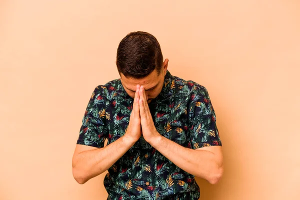 Young Hispanic Man Isolated Beige Background Praying Showing Devotion Religious — Stockfoto