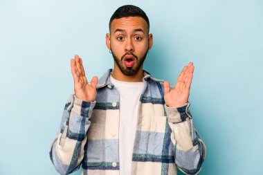 Genç İspanyol bir adam mavi arka planda izole bir fikir, ilham konsepti var.