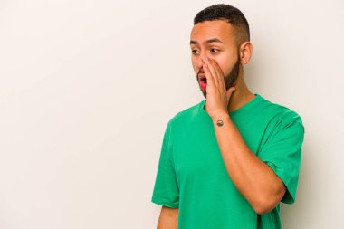 Beyaz arka planda izole edilmiş genç İspanyol adam gördüğü bir şey yüzünden şoka uğruyor..