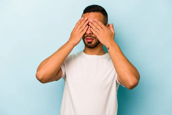 Young Hispanic Man Isolated Blue Background Afraid Covering Eyes Hands — стоковое фото