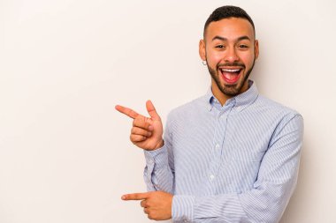 Beyaz arka planda izole edilmiş genç bir İspanyol işaret parmaklarıyla işaret ederek heyecanlanıyor..