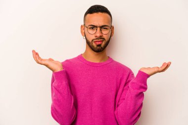 Beyaz arka planda izole edilmiş genç bir İspanyol şüpheli ve sorgulama sırasında omuz silkiyor..