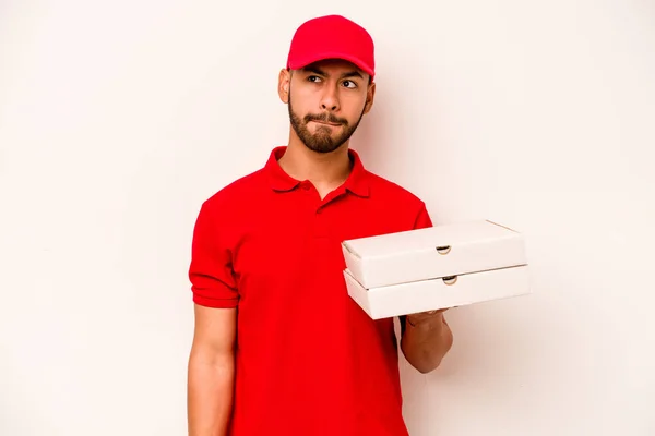 Young Hispanic Delivery Man Holding Pizzas Isolated White Background Confused — Stockfoto