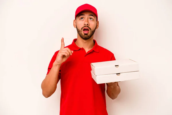 Young Hispanic Delivery Man Holding Pizzas Isolated White Background Pointing — ストック写真