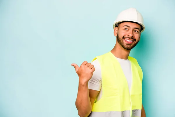 Young Laborer Hispanic Man Isolated Blue Background Points Thumb Finger — 스톡 사진