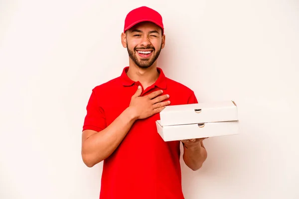 Young Hispanic Delivery Man Holding Pizzas Isolated White Background Laughs — Stockfoto