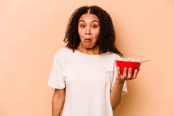 Young African American Woman Holding Bowl Cereals Isolated Beige Background — Stockfoto