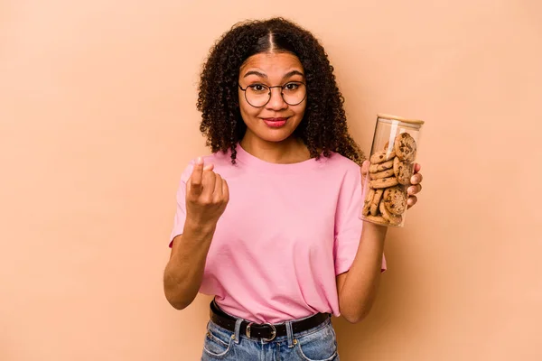 Young African American Woman Holding Cookies Jar Isolated Beige Background —  Fotos de Stock