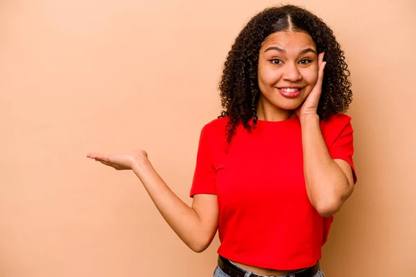 Ung Afrikansk Amerikansk Kvinna Isolerad Beige Bakgrund Håller Kopia Utrymme — Stockfoto