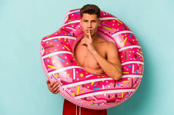 Young Caucasian Man Holding Inflatable Donut Isolated Blue Background Keeping —  Fotos de Stock