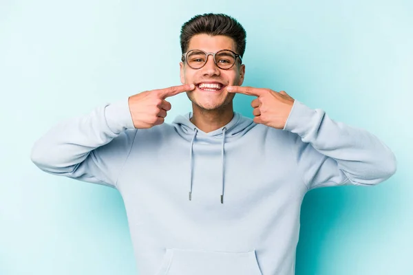 Mladý Běloch Izolovaný Modrém Pozadí Usmívá Ukazuje Prsty Ústa — Stock fotografie