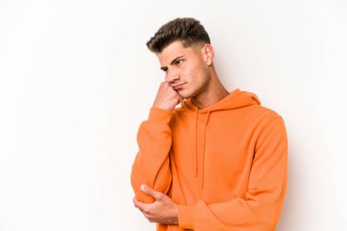 Beyaz arka planda izole edilmiş, üzgün ve dalgın hisseden genç beyaz bir adam fotokopi alanına bakıyor..