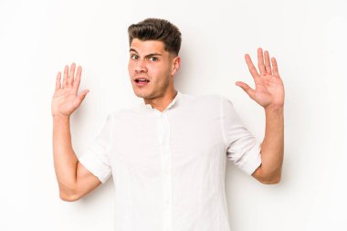 Beyaz arka planda izole genç beyaz adam yakın bir tehlike nedeniyle şoka uğruyor