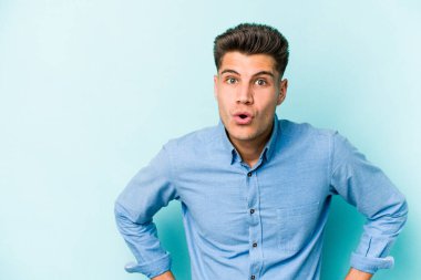 Kafkasyalı genç adam mavi arka planda izole edilmişti. Gördüğü bir şey yüzünden şok olmuştu..